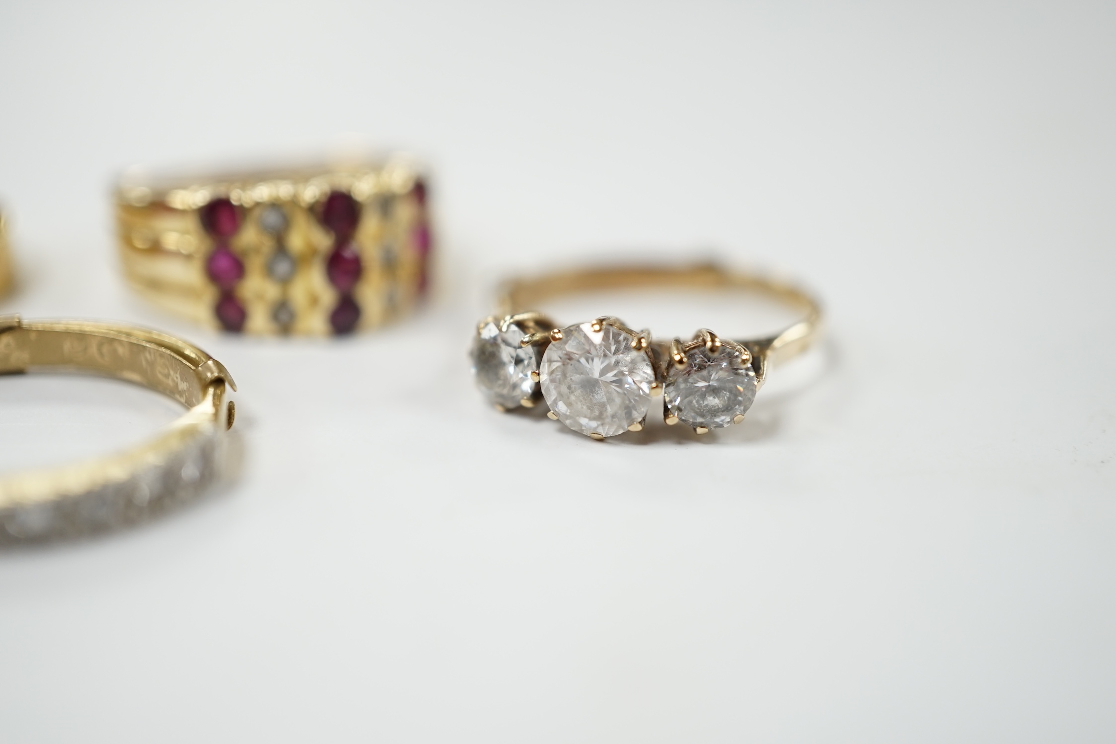 An 18ct and diamond chip set half hoop ring, size L/M, an 18ct gold band and two 9ct and gem set rings. Condition - fair